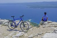 Fahrradfahrer auf Klippe mit Meeresblick, I.D. Riva Tours