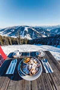 Essen vor Bergkulisse, Essen auf Tisch vor Bergpanorama, Essen mit Blick auf verschneite Gipfel,